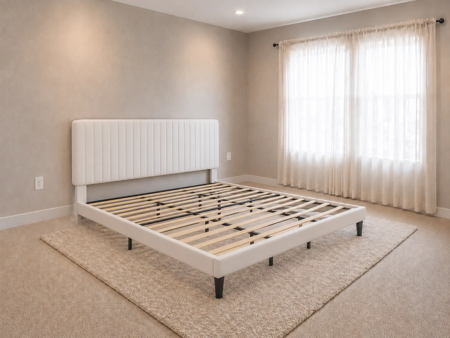 Off-white velvet King platform bed with a vertical channel-tufted headboard set against the bedroom wall on the jute rug