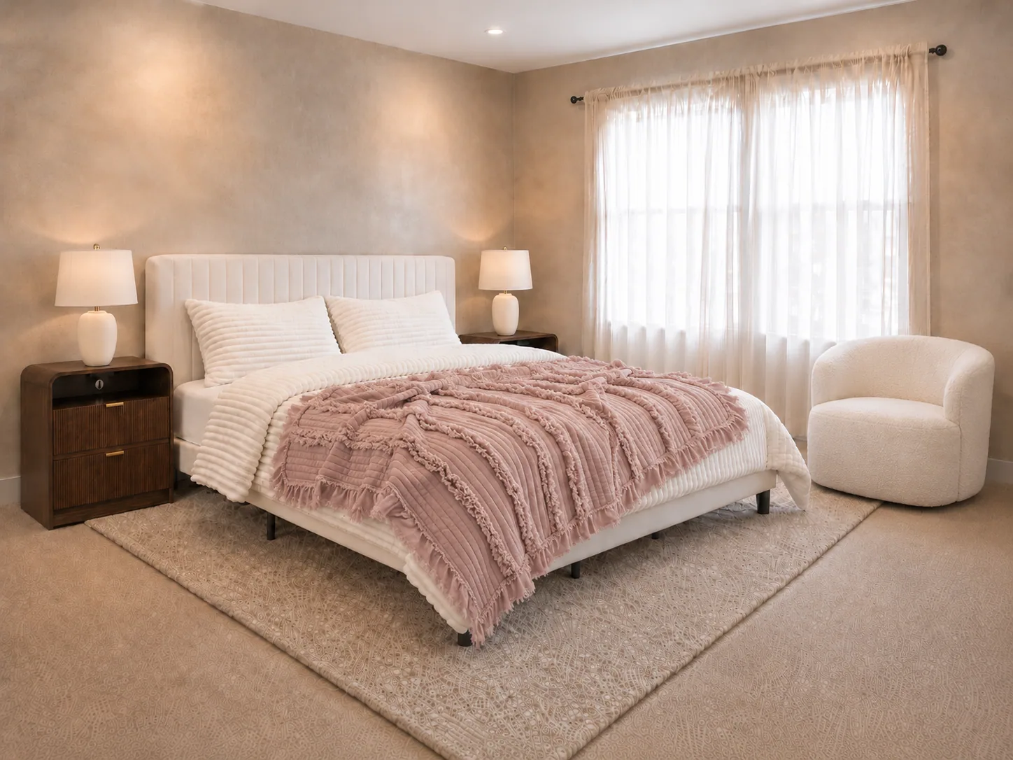 Dusty mauve quilted throw blanket folded across the foot of the cream King bed